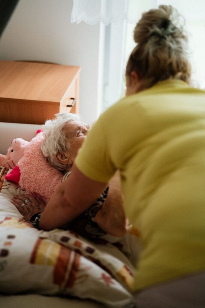Crafting Captivating Headlines: Your awesome post title goes here Nurse assisting elderly woman in a comfortable medical facility setting.