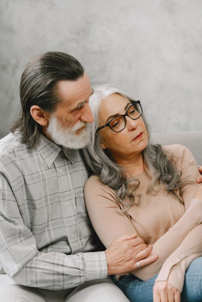 Mastering the First Impression: Your intriguing post title goes here Elderly couple sitting and embracing on a cozy indoors setting, conveying warmth and togetherness.