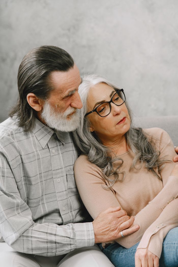 Mastering the First Impression: Your intriguing post title goes here Elderly couple sitting and embracing on a cozy indoors setting, conveying warmth and togetherness.