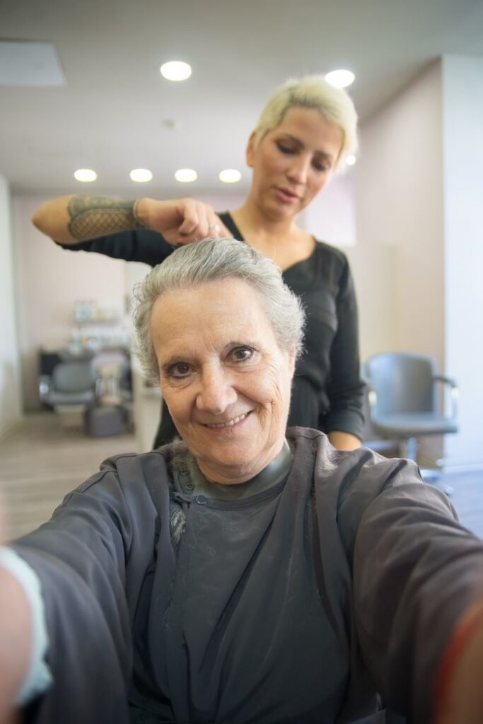The Art of Drawing Readers In: Your attractive post title goes here Smiling senior woman with hairdresser in a salon. A joyful hair styling session indoors.